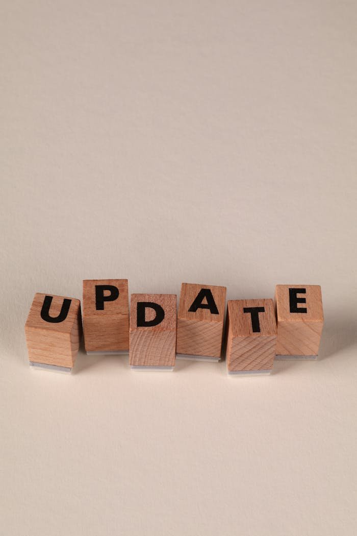 about-img Wooden blocks spelling 'UPDATE' on a neutral background, perfect for business and communication themes.