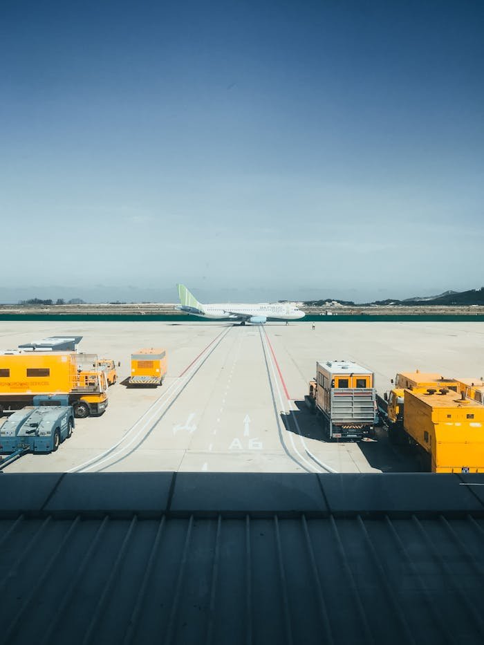 why-choose-us Aviation scene with airplane and ground support vehicles at Cam Ranh airport runway in Vietnam.