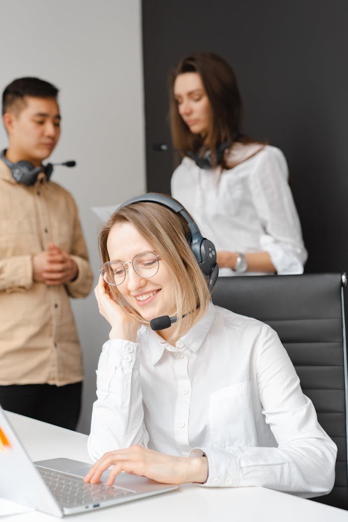 Crafting Captivating Headlines: Your awesome post title goes here Customer service team working together in a modern call center with headsets and laptops.