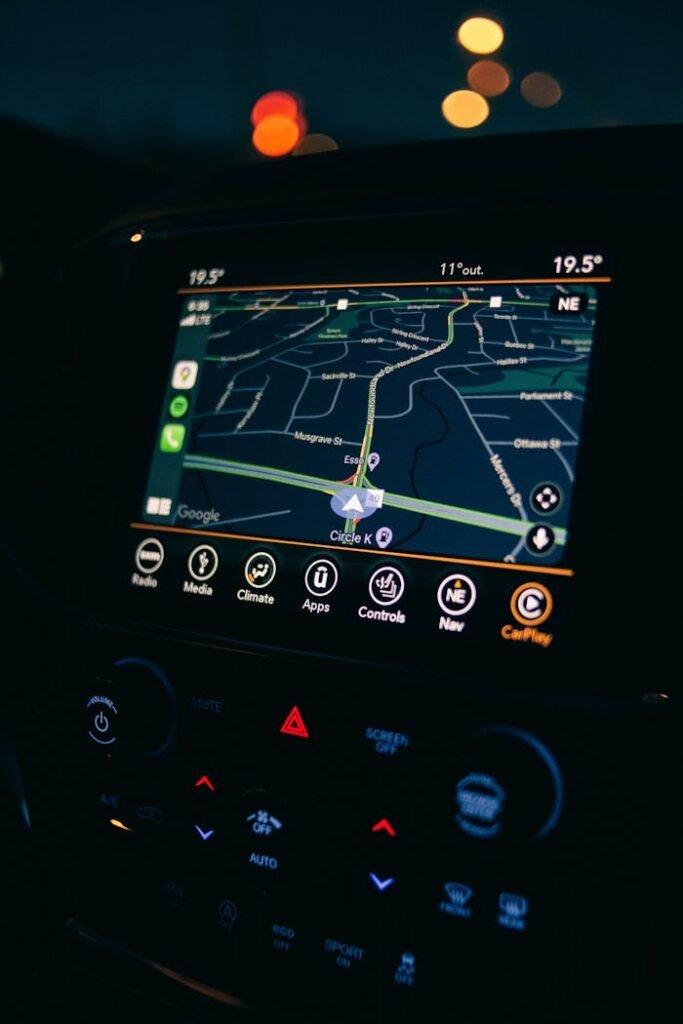 pexels photo 9966007 A car's GPS navigation screen showing a map interface illuminated during a night drive.
